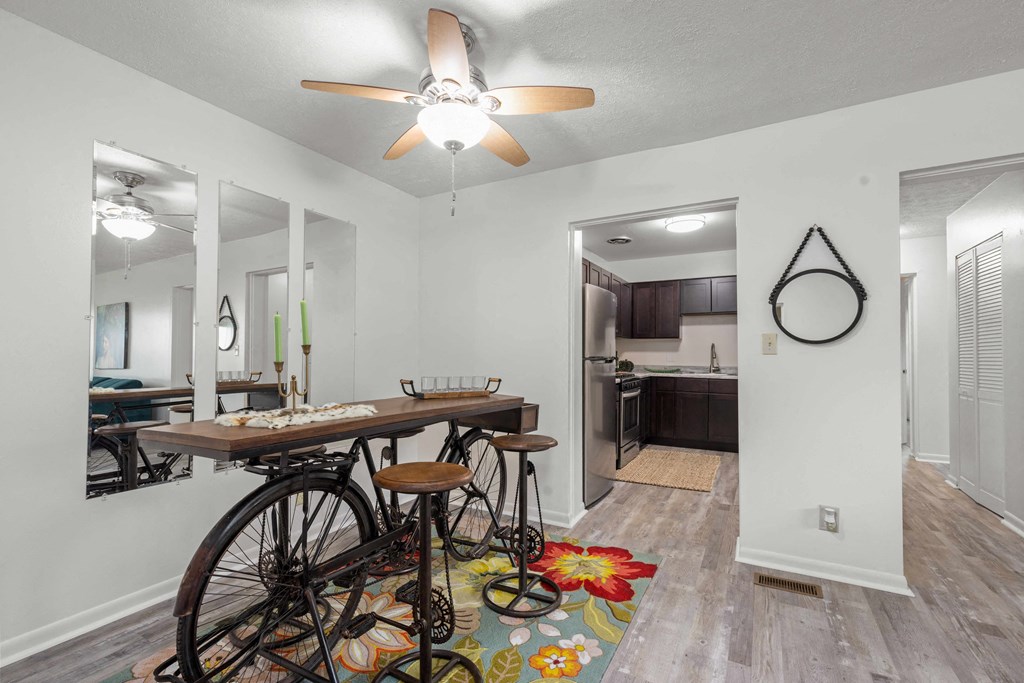 A room with a bicycle and a table.