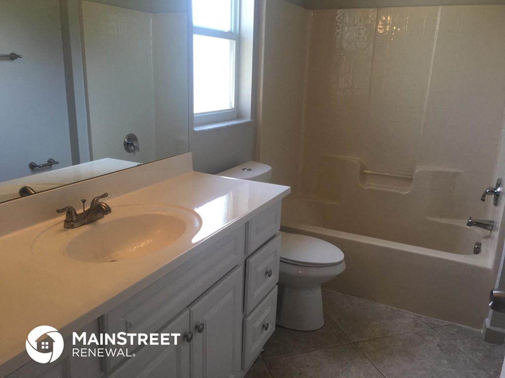 a white bathroom with a sink and a toilet