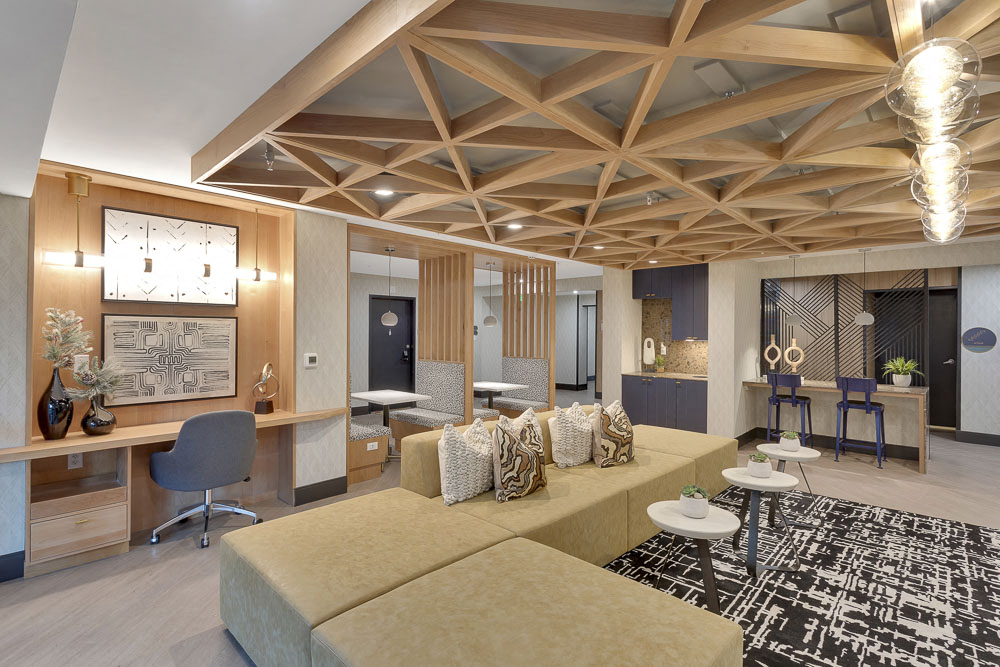 a living room with a couch and a desk