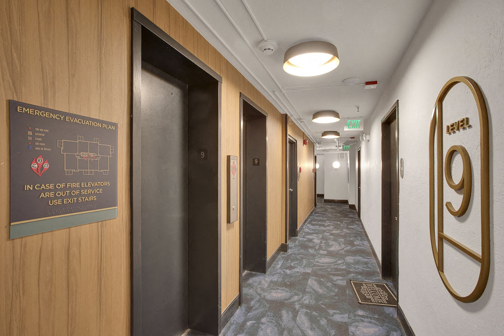 a corridor with a sign for the 9th floor of a building