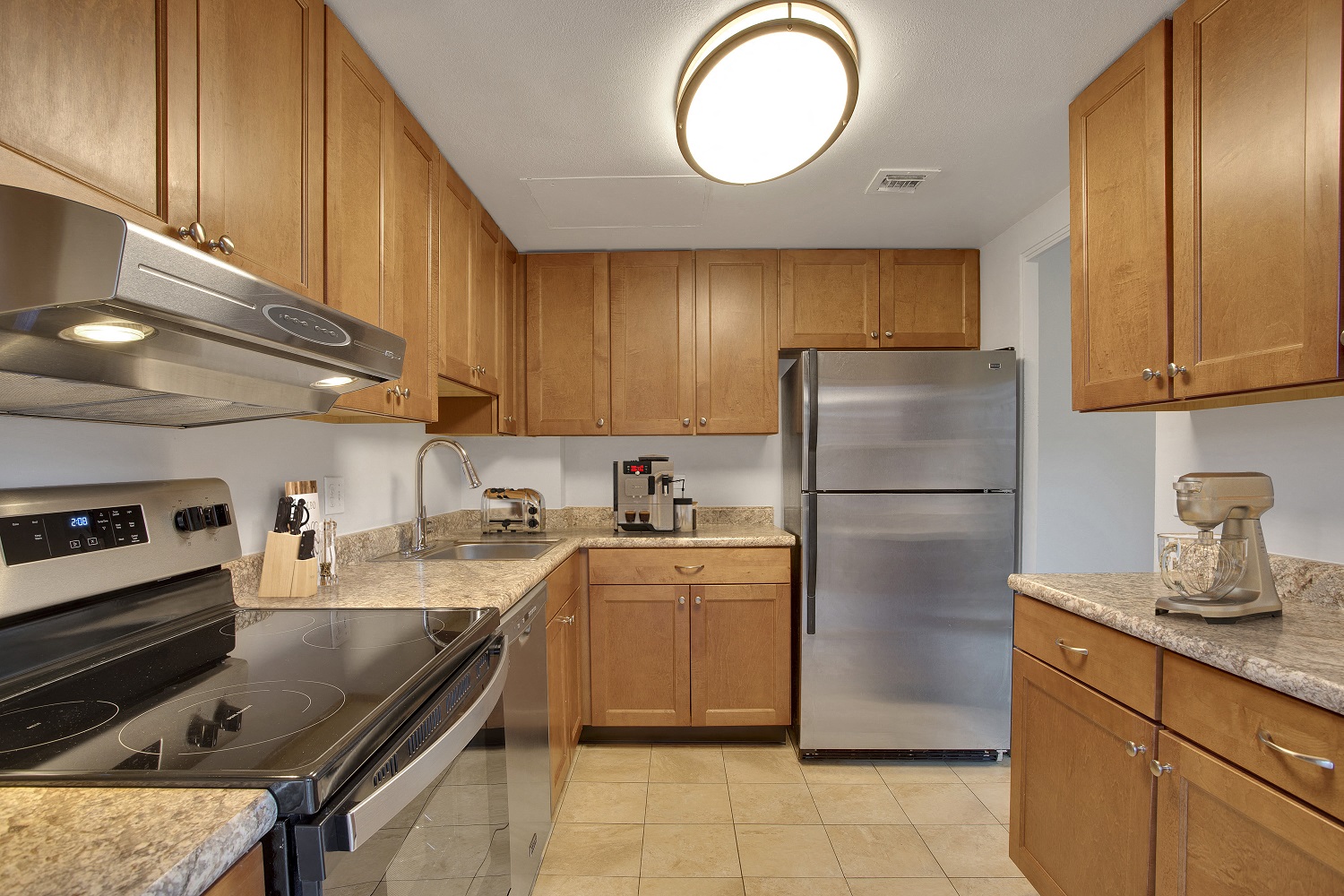 a kitchen with stainless steel appliances and wooden cabinets