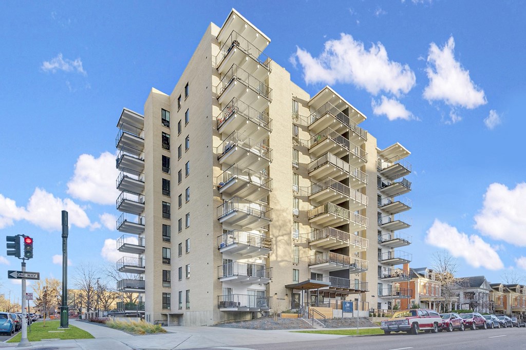 a high rise building with balconies on a city street