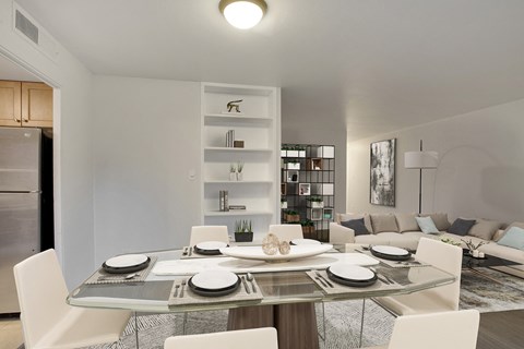 a living room and dining room with a table and chairs
