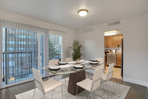 a dining room with a glass table and chairs
