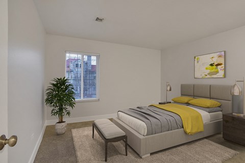 a bedroom with a bed and a plant and a window
