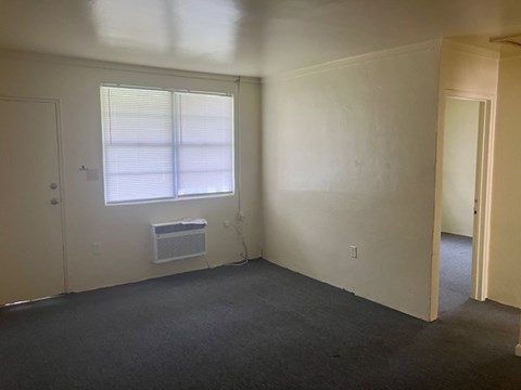 A room with a window and air conditioner.