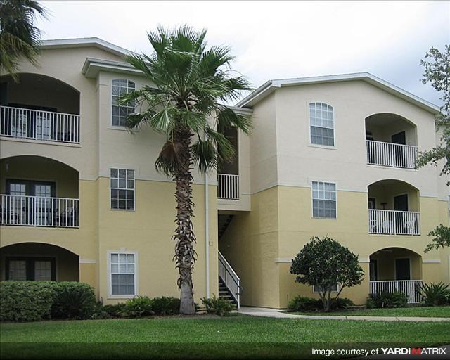 a large building with a palm tree in front of it