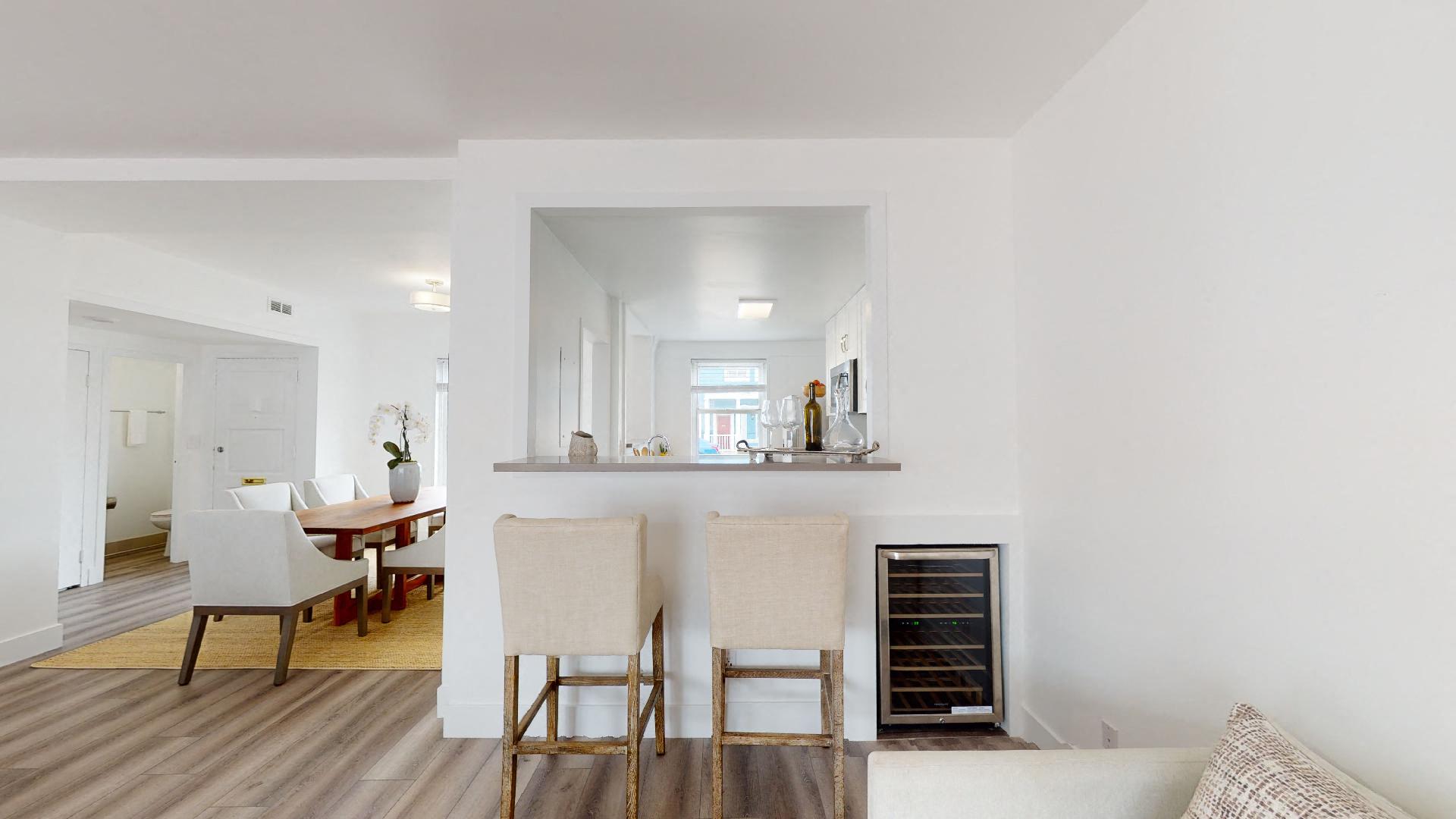 a living room and dining room with a table and chairs