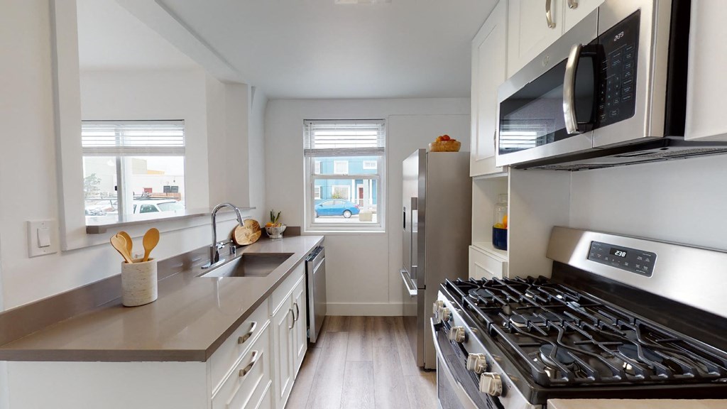 a kitchen with stainless steel appliances and white cabinets