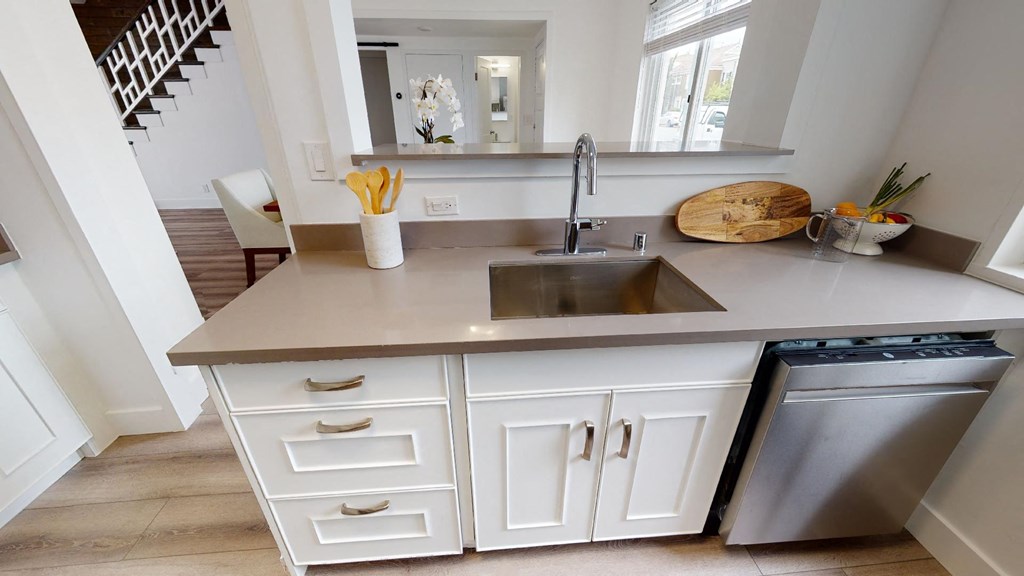 a small kitchen with a sink and a dishwasher