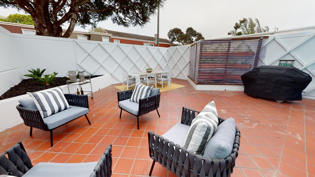 the patio has a table and chairs and a couch