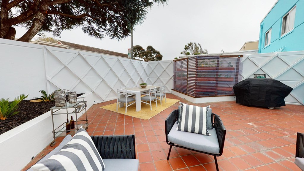 the patio has seating and a table with chairs