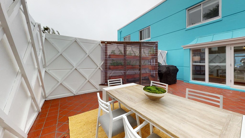 a dining area with a wooden table and chairs
