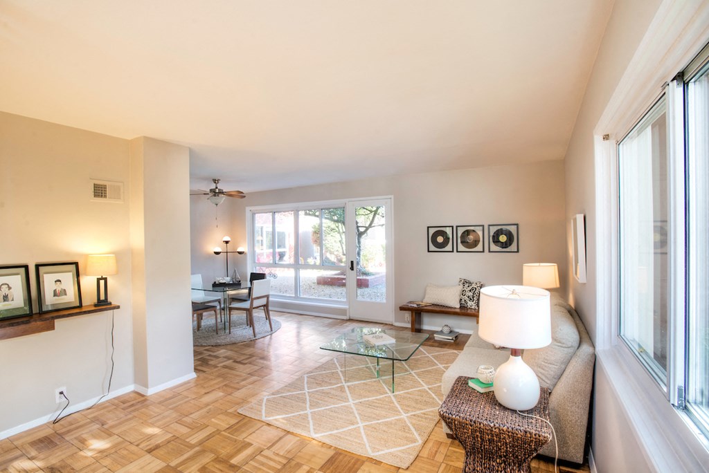 a living room with a couch and a coffee table and a sliding glass door