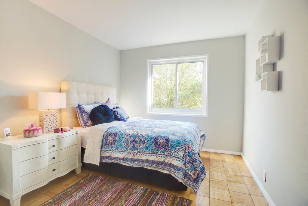 a bedroom with a bed and a window