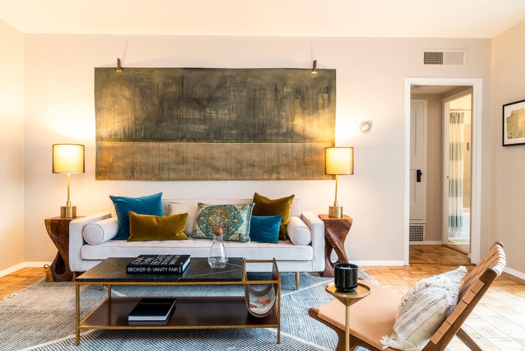 a living room with a couch and a painting on the wall
