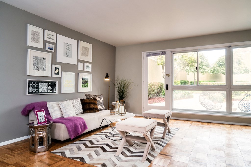 a living room with a couch and a table and a window