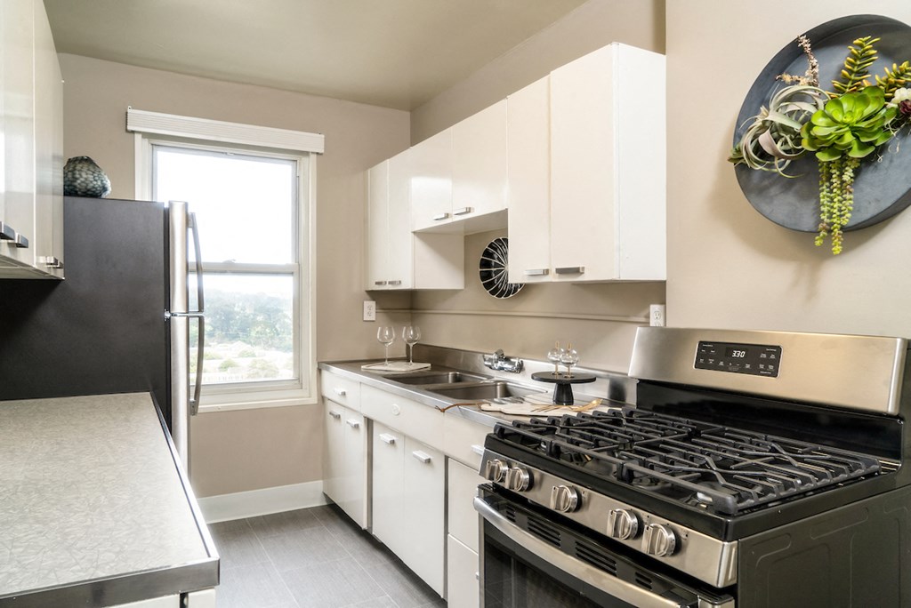a kitchen with stainless steel appliances and white cabinets