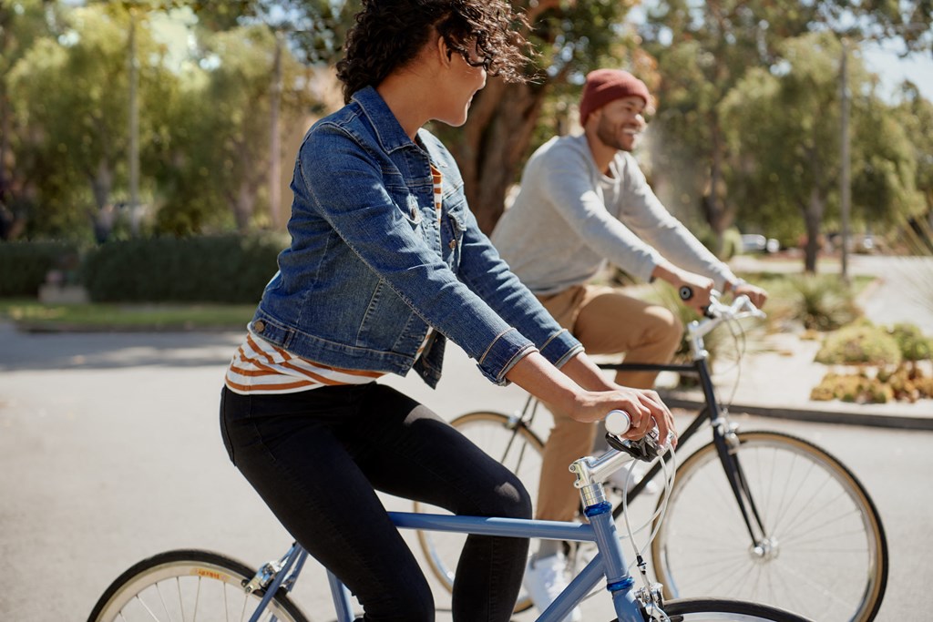 a man and a woman riding bicycles on a bike