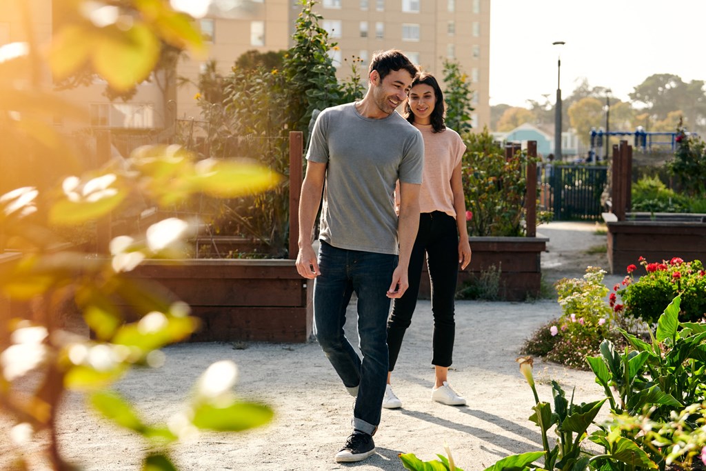 a man and a woman walking together in a park