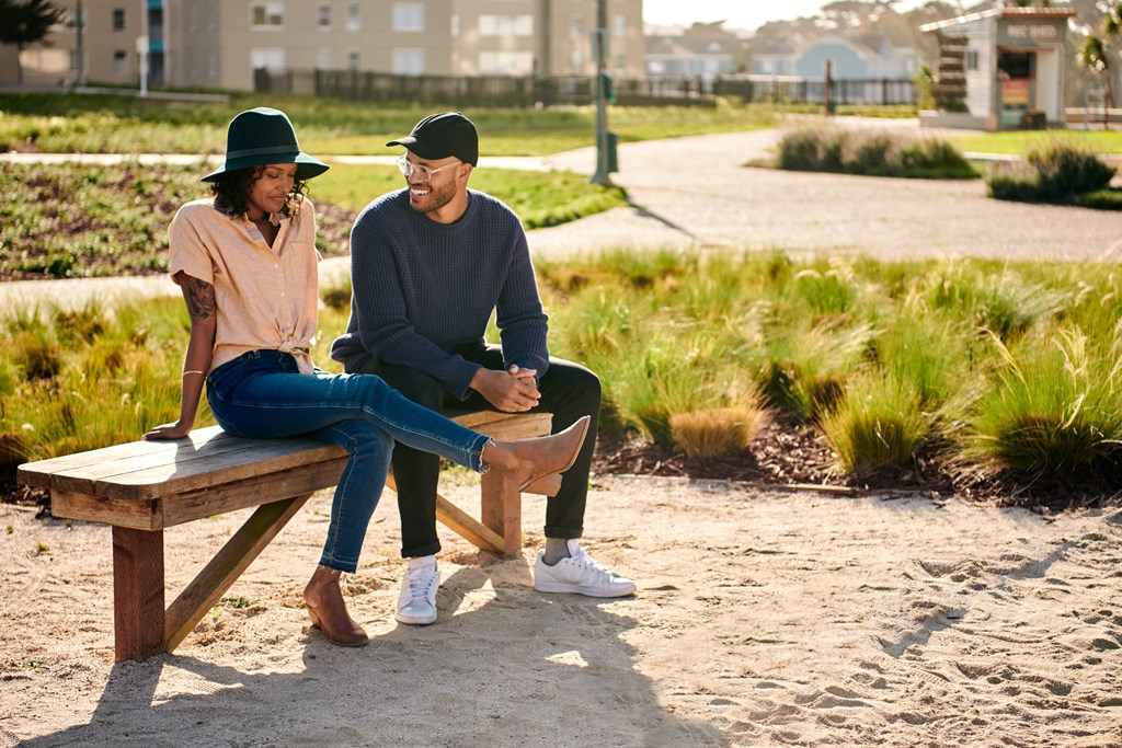 a man and a woman sitting on a bench