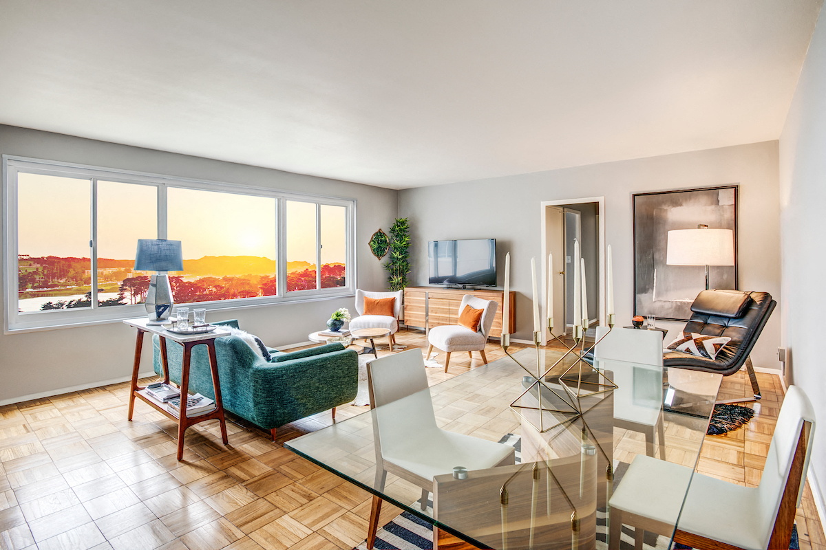 a living room with a glass table and chairs