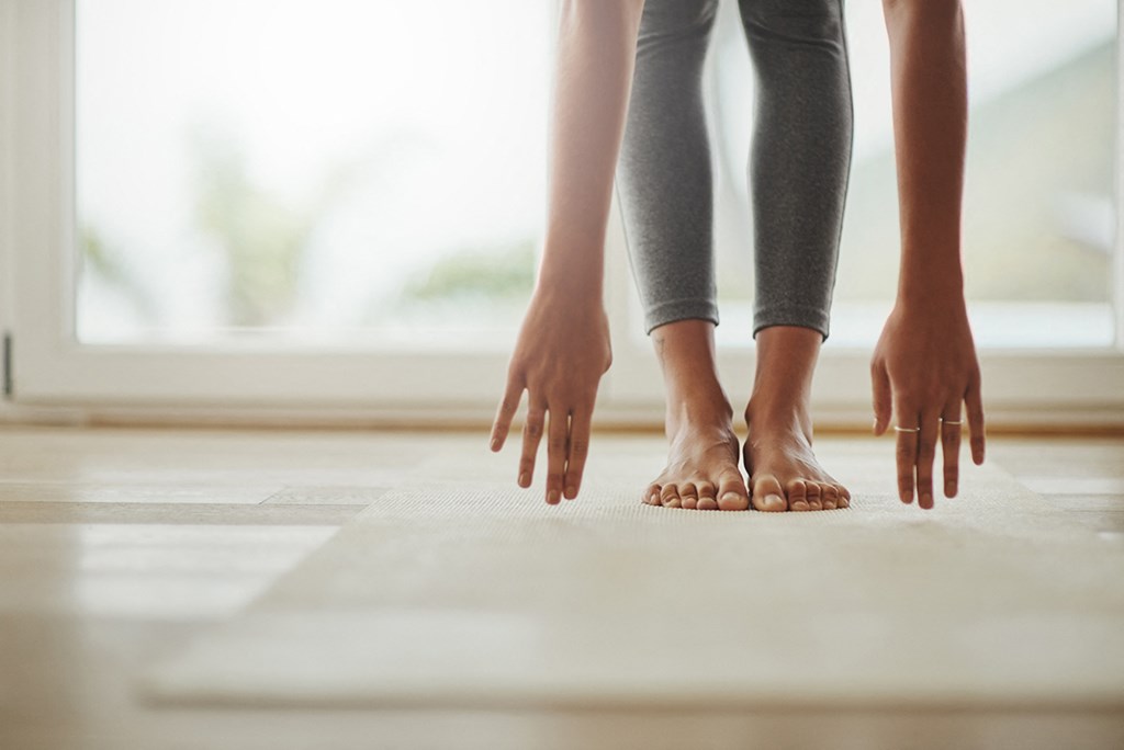 a woman standing on the floor with her hands on the ground
