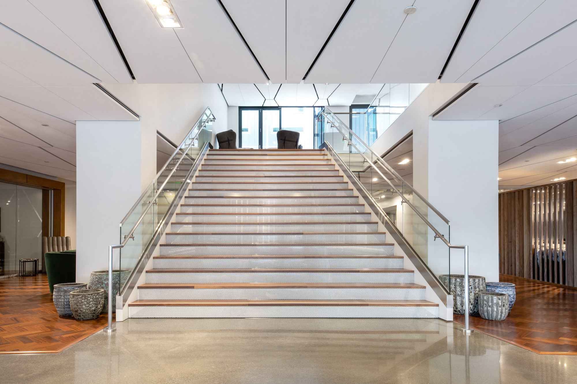 the lobby of a building with a large staircase and a lobby escalator