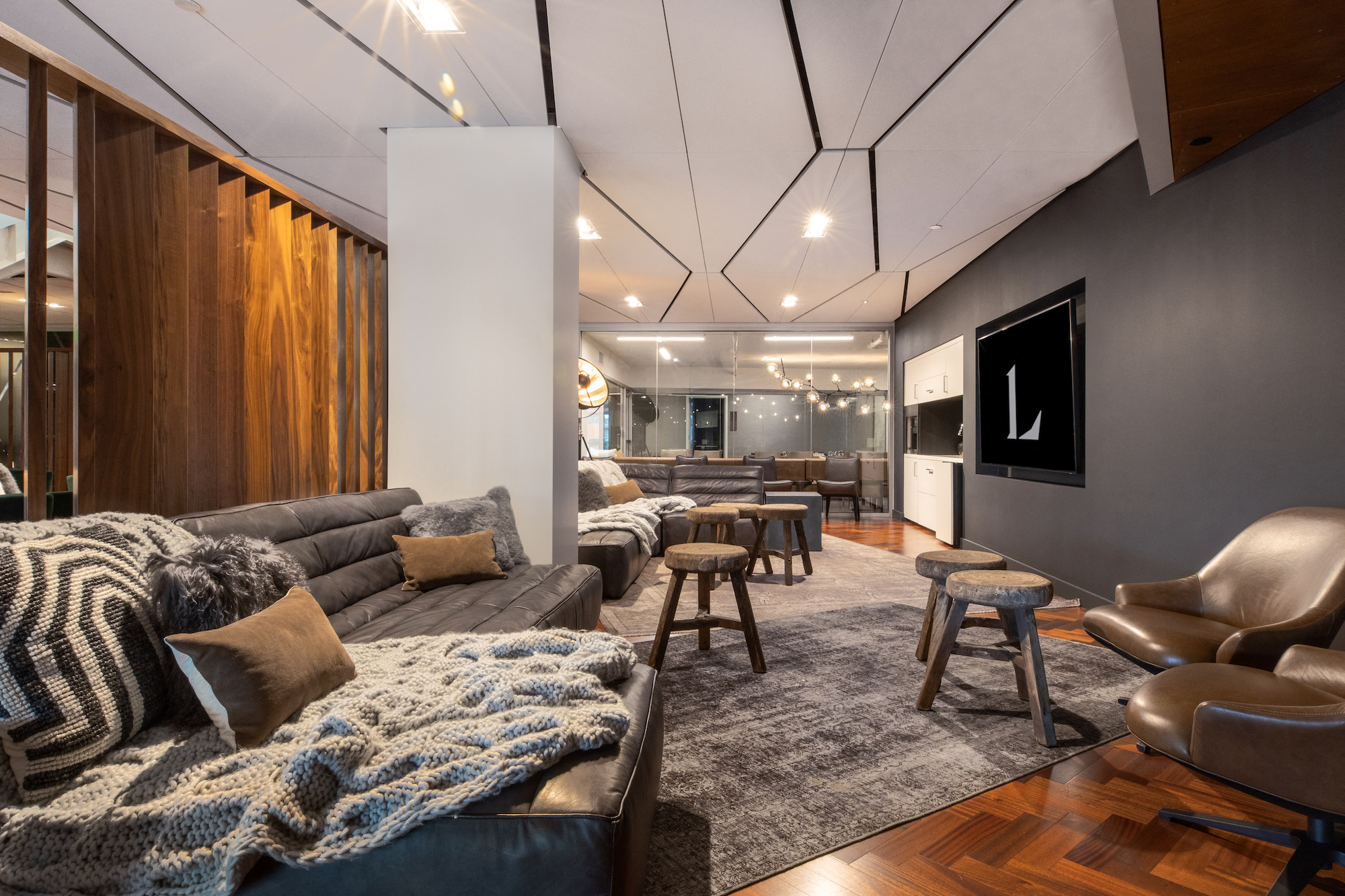 a living room with couches and chairs and a tv