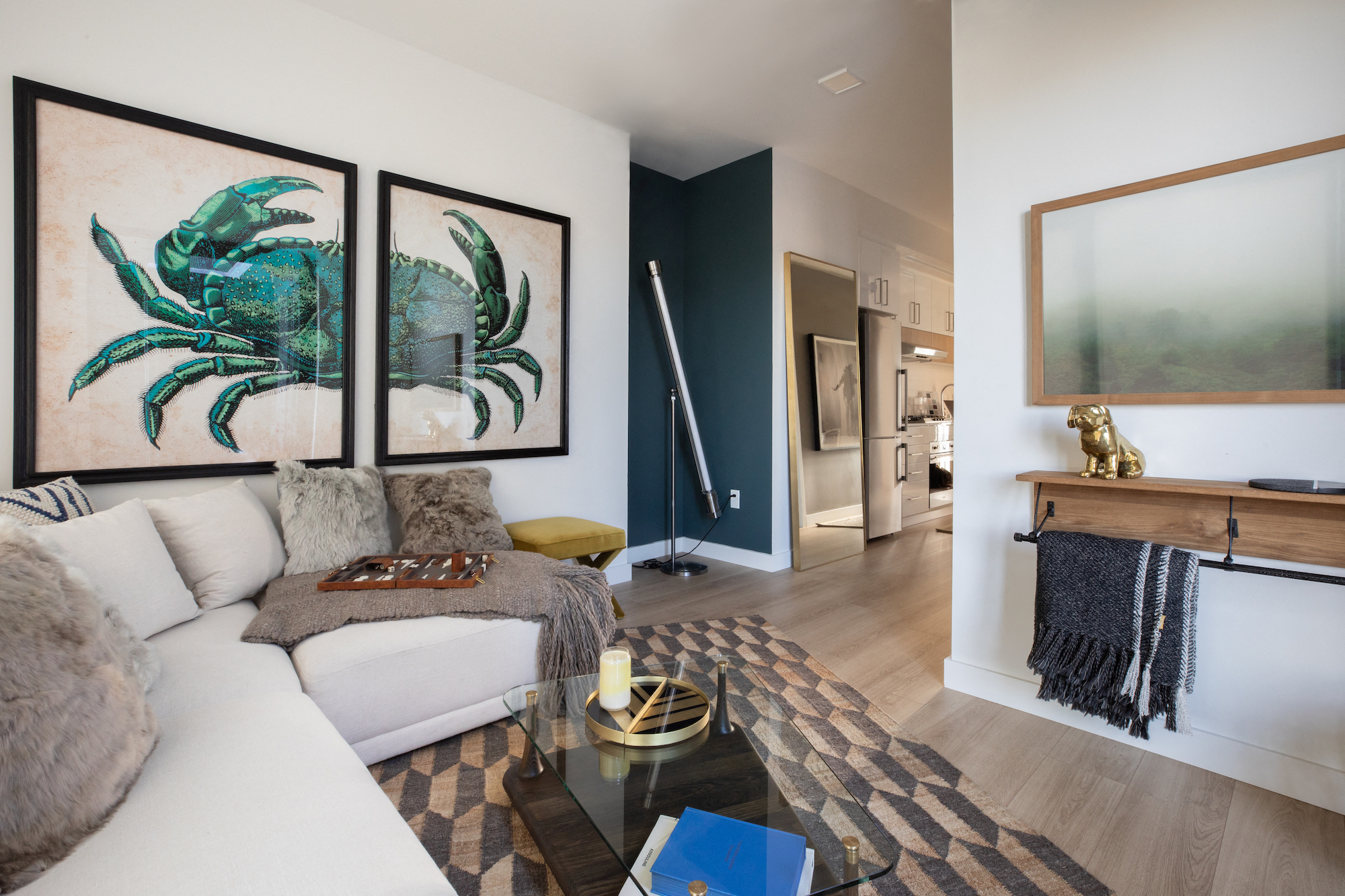 a living room with a couch and two paintings on the wall