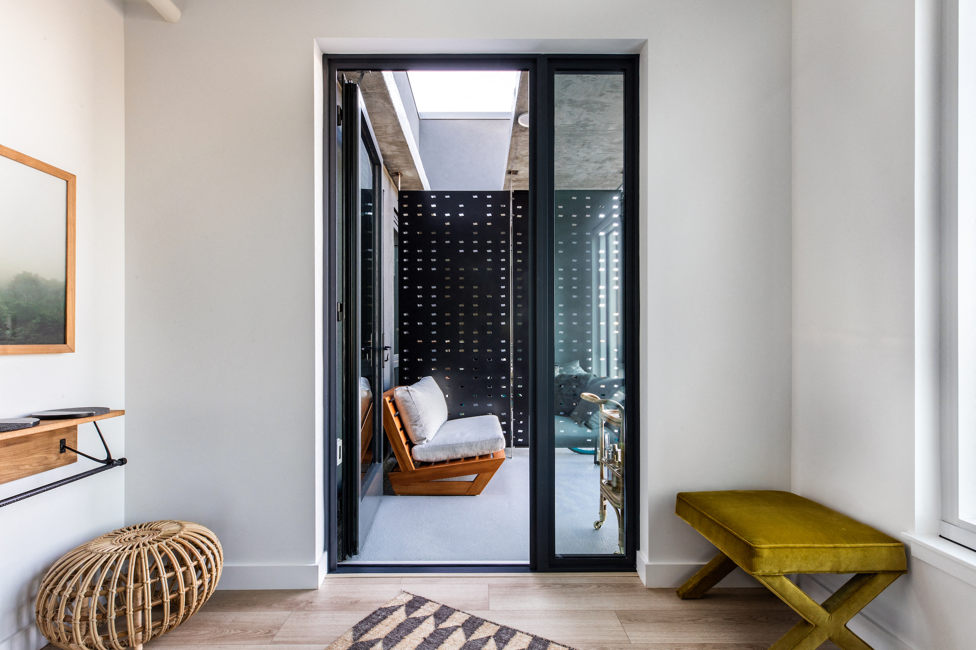 a small room with a chair and a door to a balcony