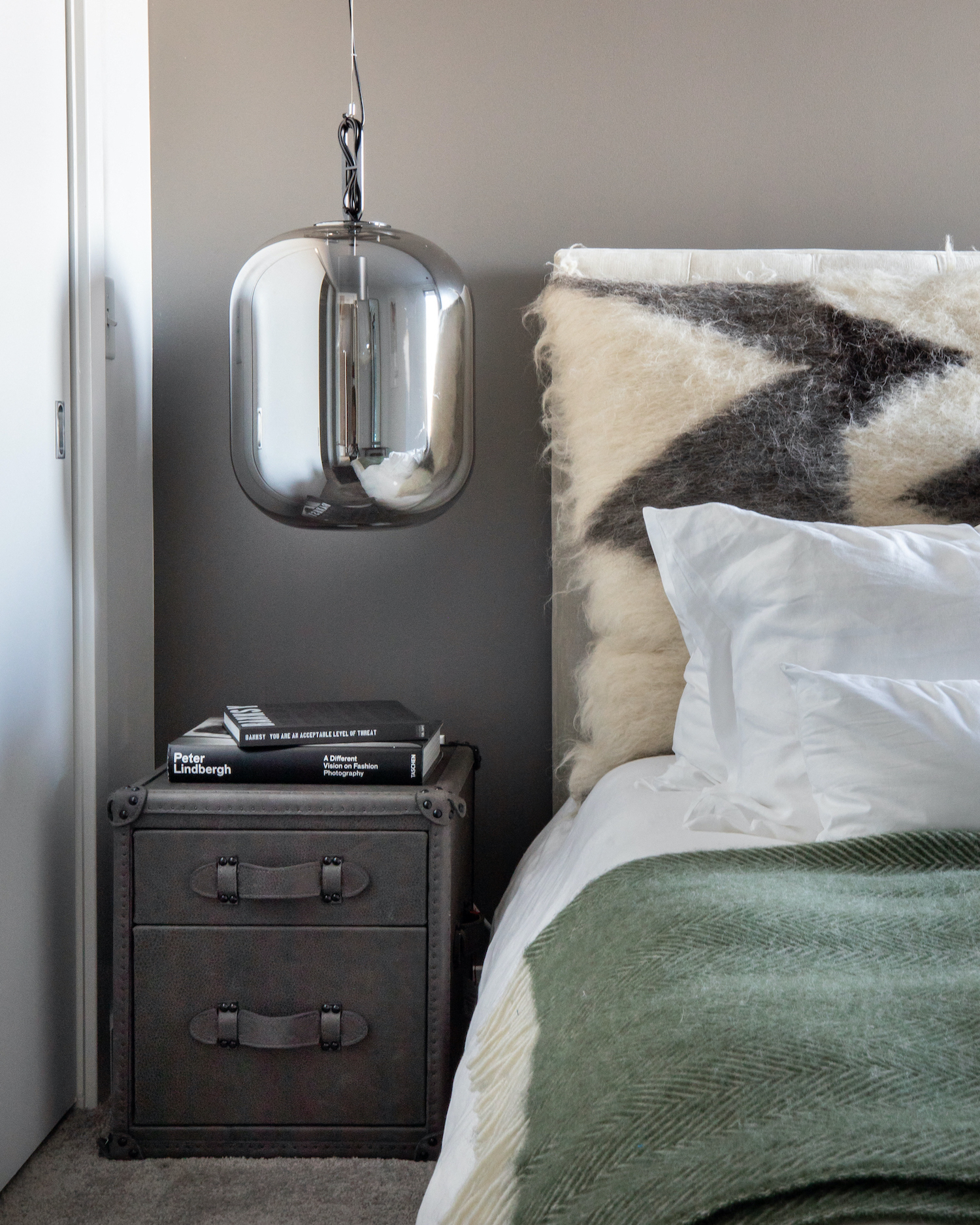 a bedroom with a bed and a lamp and a night stand