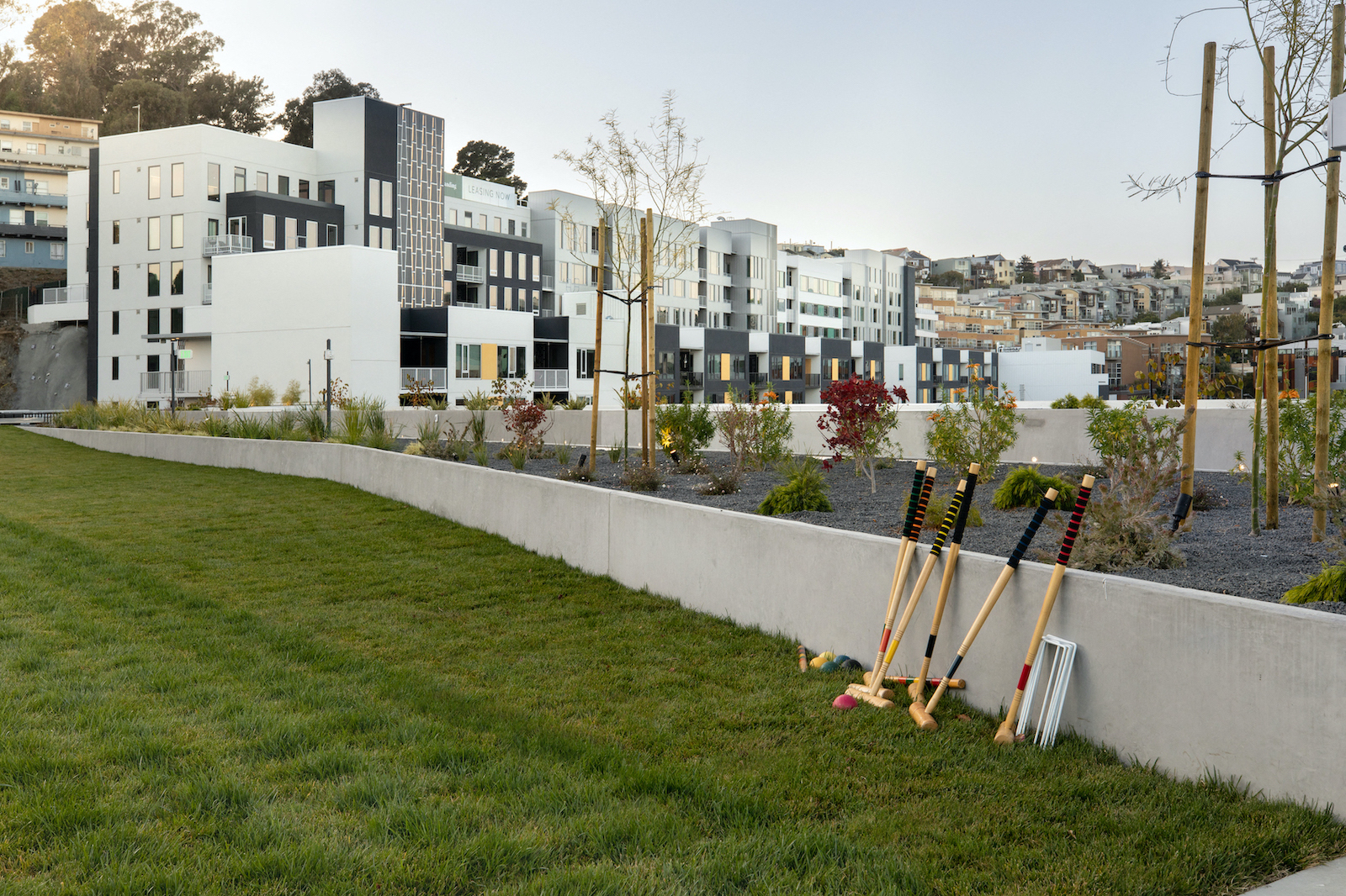 a row of baseball bats are leaned against a wall in front of a building