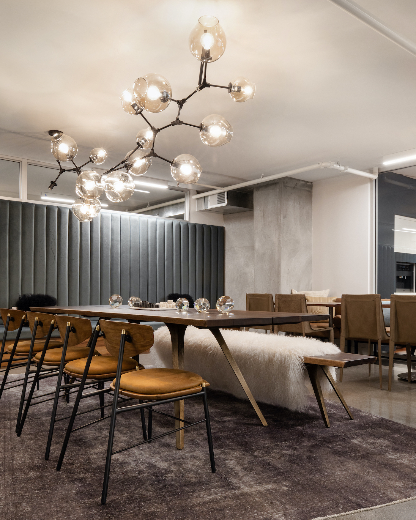 a dining room with a long table and chairs and a chandelier