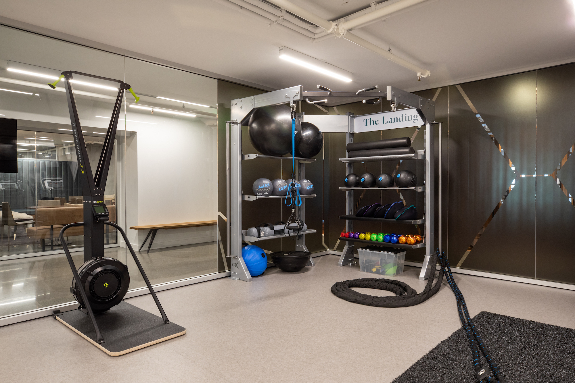 a workout room with weights and other equipment in a studio space