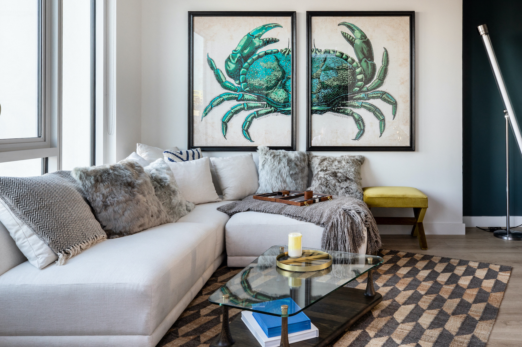 a living room with a couch and two pictures of a crab