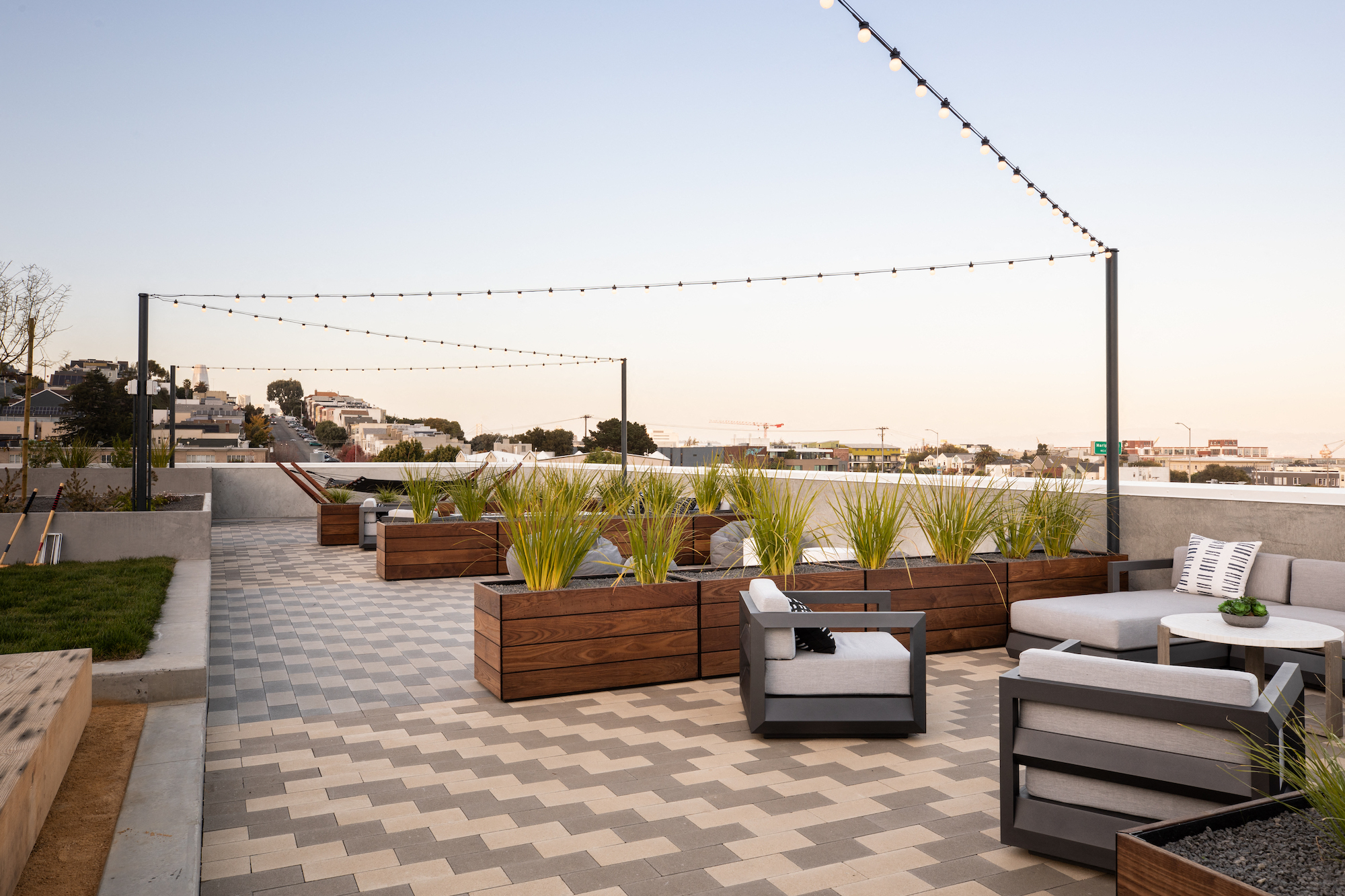 a roof top patio with furniture and plants