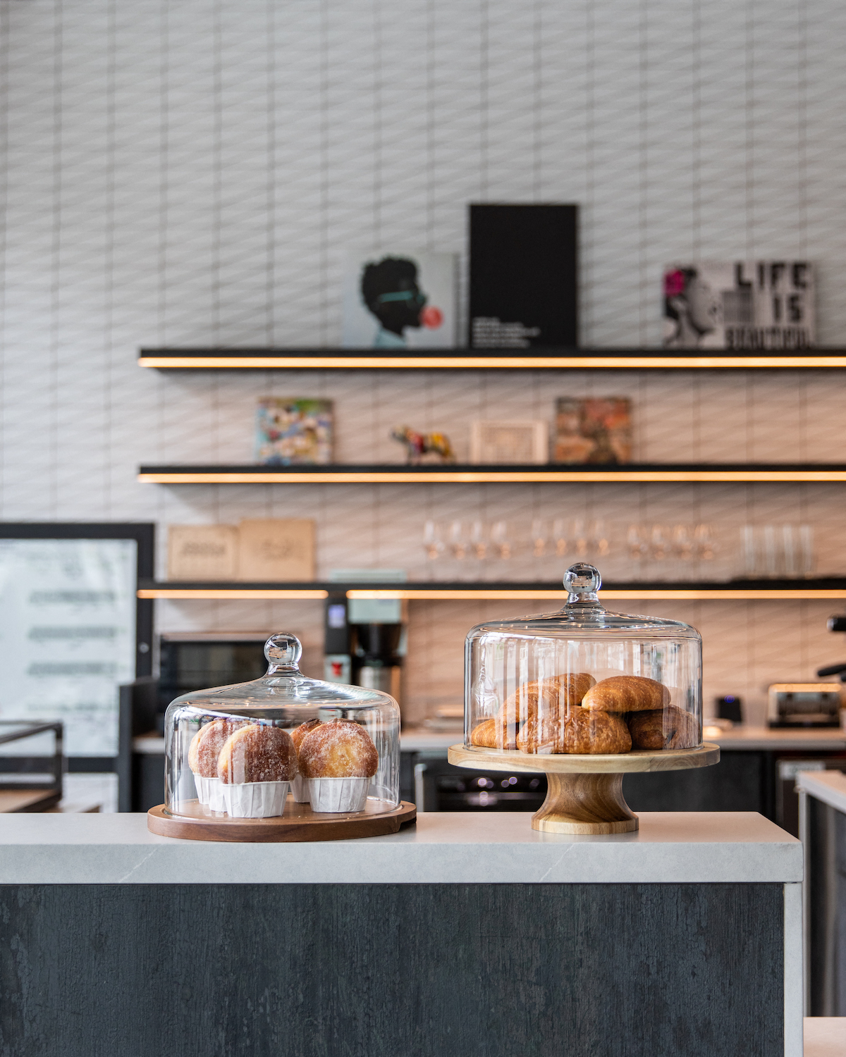 a display case filled with donuts on a counter in a bakery