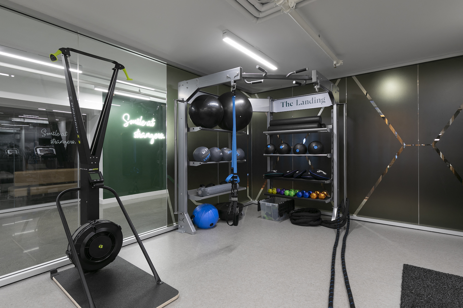 a workout room with weights and balls in a gym on the wall