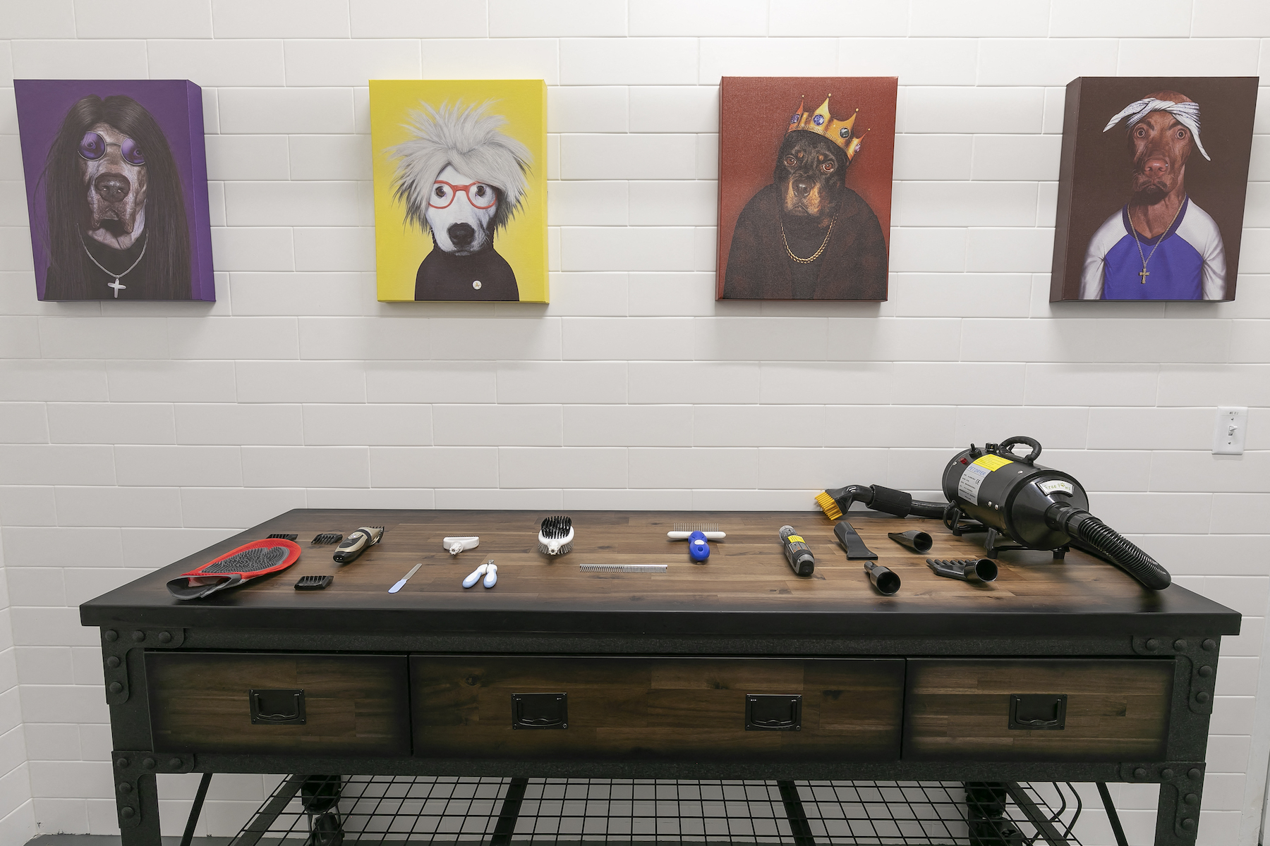 a room with paintings and a table with tools on it