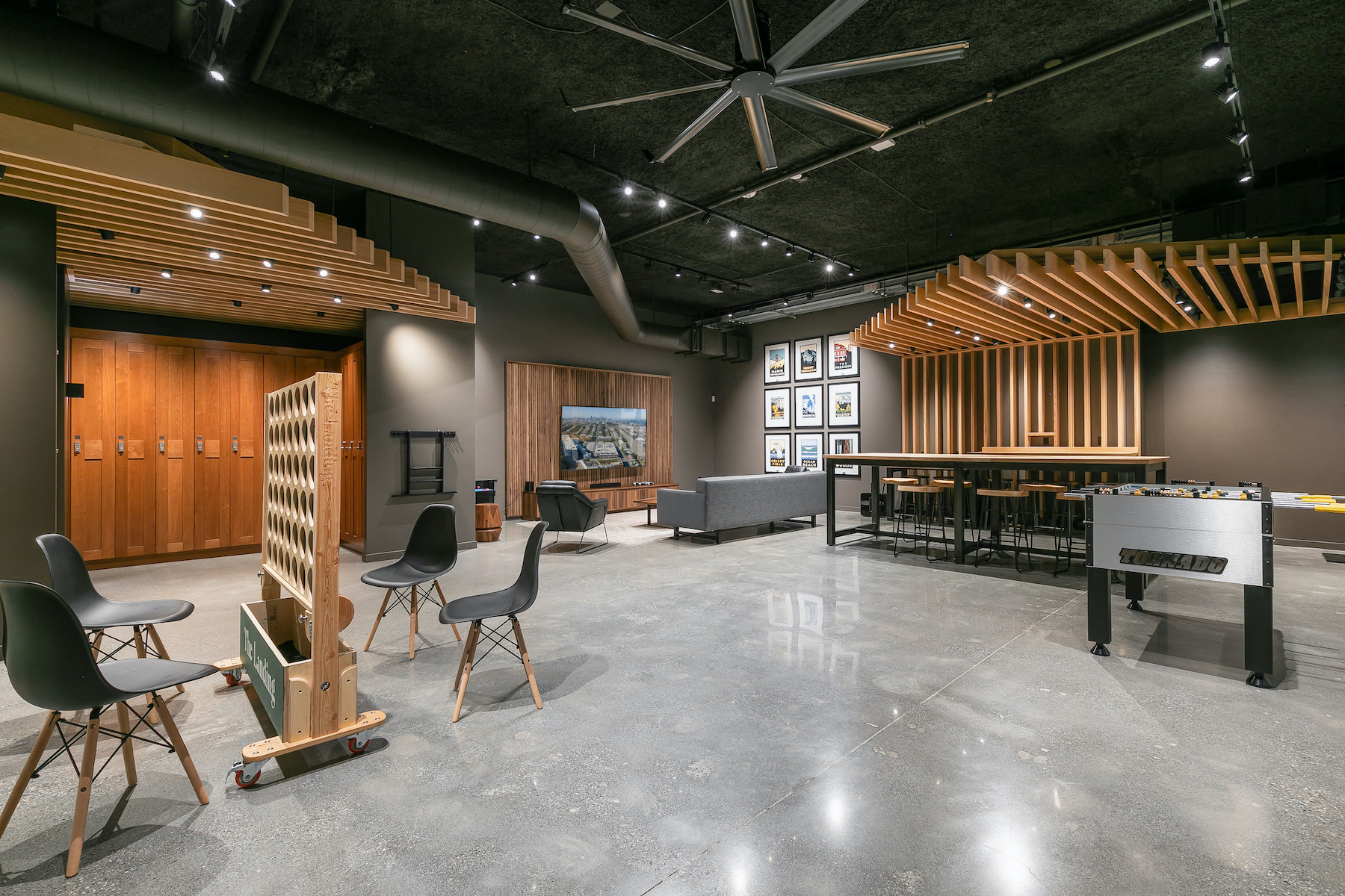 a large room with a table and chairs and a piano