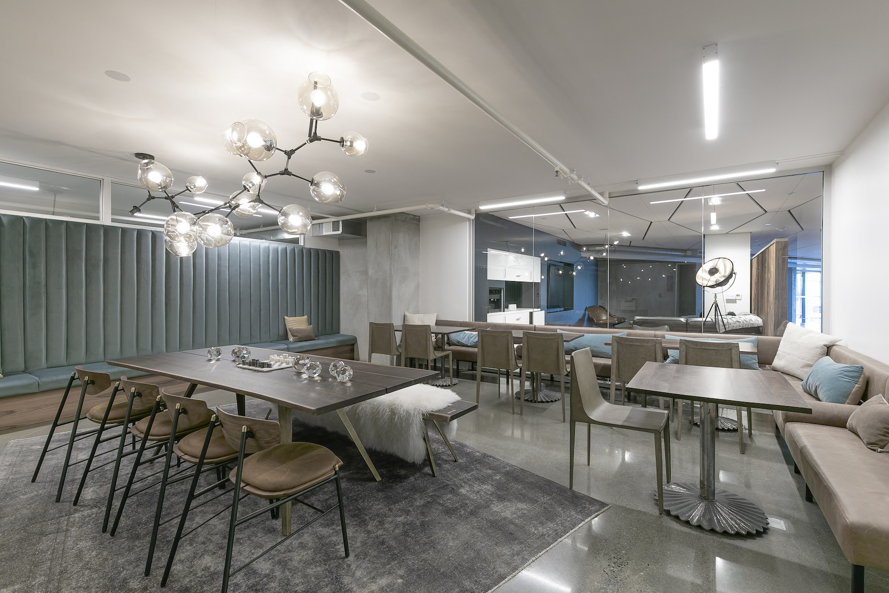 a dining room with tables and chairs and a living room
