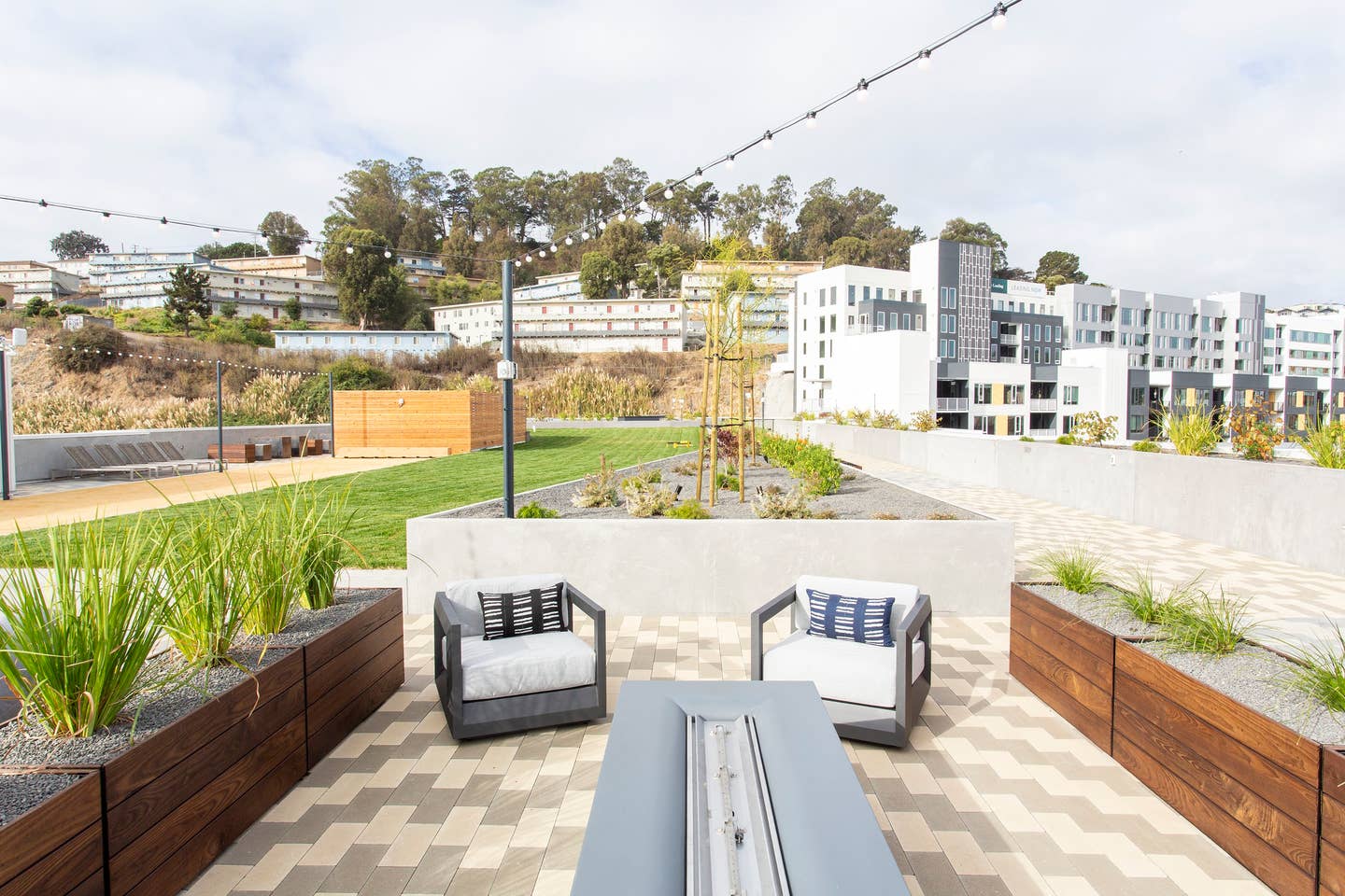 a roof terrace with lounge chairs and a table