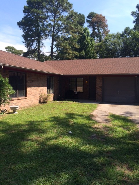 A house with a brown roof and a garage door.