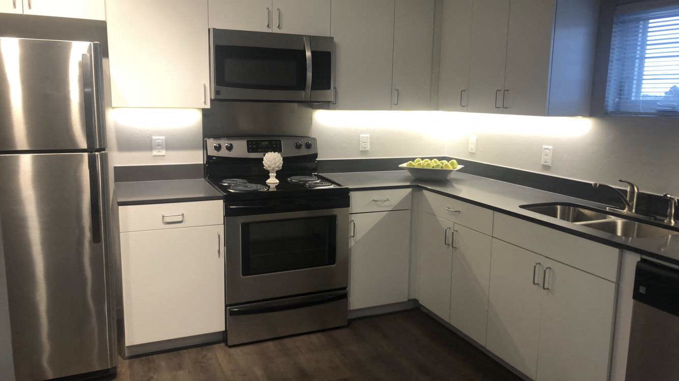 a kitchen with stainless steel appliances and white cabinets