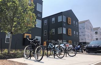 a row of bikes parked in front of a building