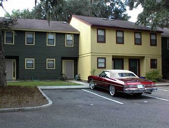 a red car parked in front of a house