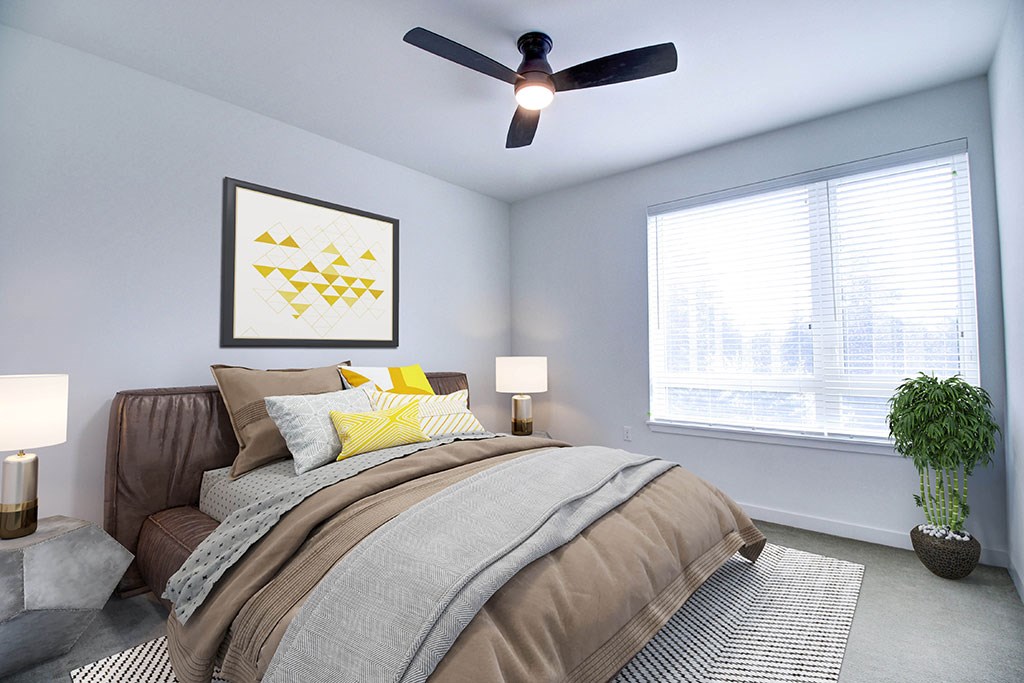 a bedroom with a bed and a ceiling fan