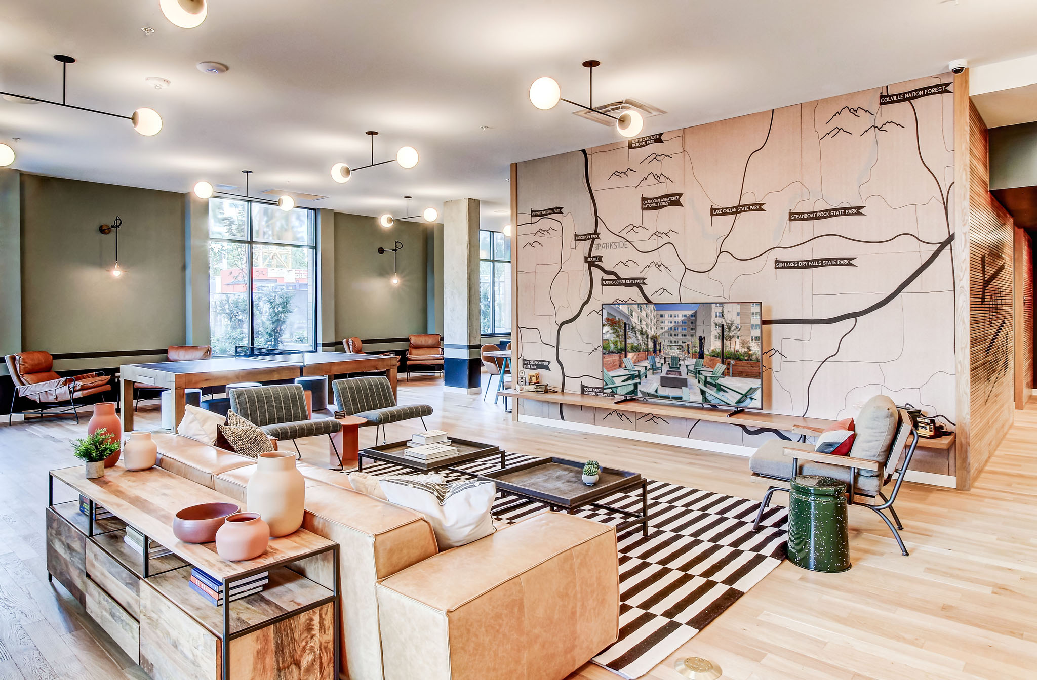 a living room with furniture and a large map on the wall