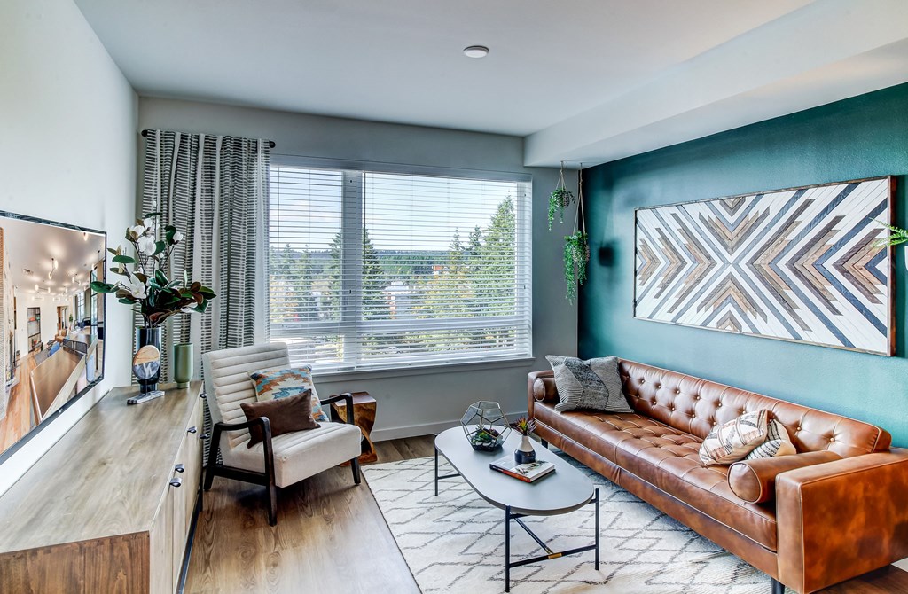 a living room with blue walls and a brown couch